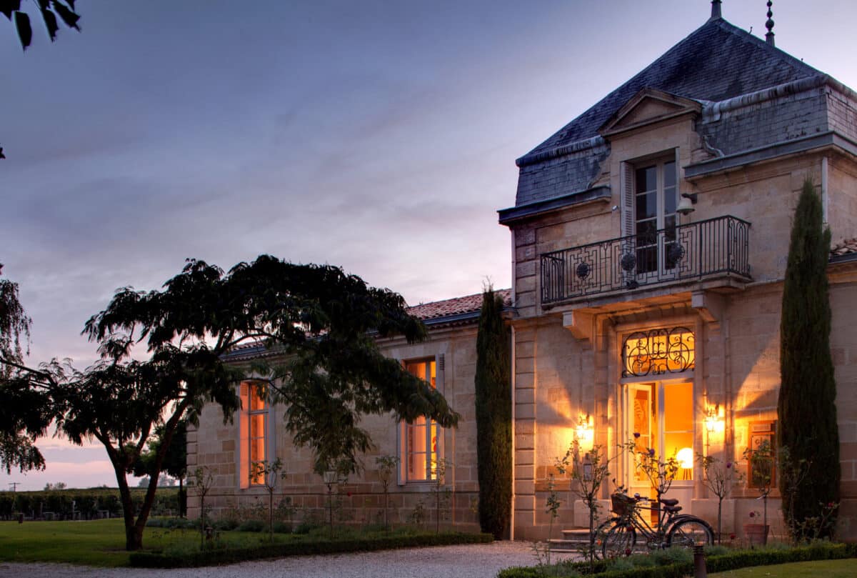 Elegant stone building of COMO Cordeillan-Bages at twilight.
