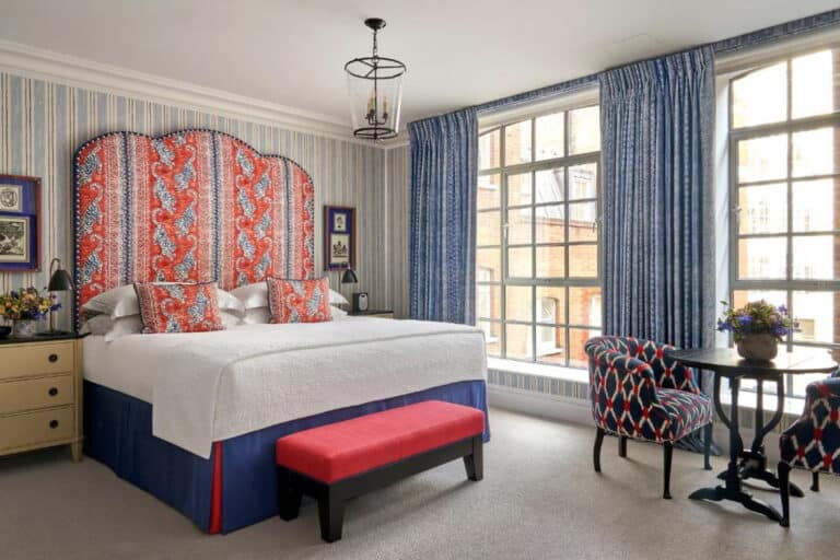 White beedroom with red patterned headboard