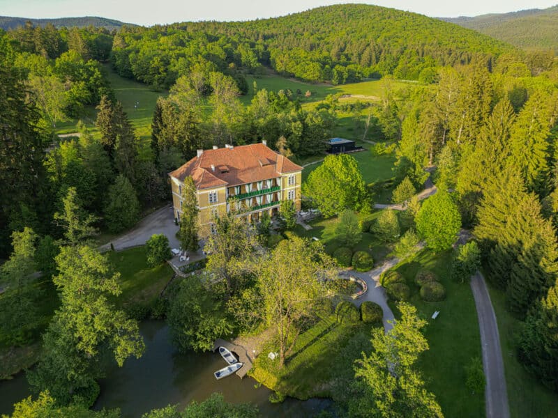 Lush Zabola estate surrounded by greenery.