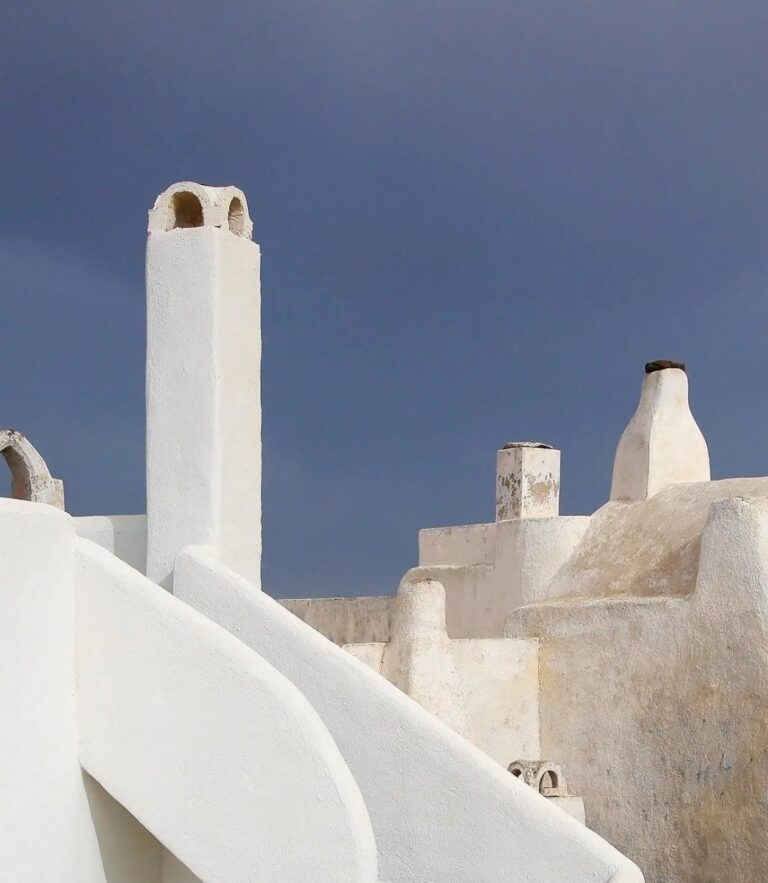 Whitewashed rooftops and chimneys of Pyrgos village at Alleys All-Suite Hotel & Spa, Pyrgos, Santorini