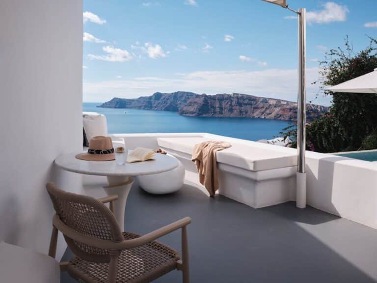 Terrace daybed and table facing the caldera cliffs at Canaves Sunday, Oia, Santorini