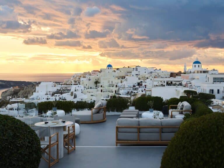 Terrace lounge at sunset with Oia village beyond at Canaves Sunday, Oia, Santorini