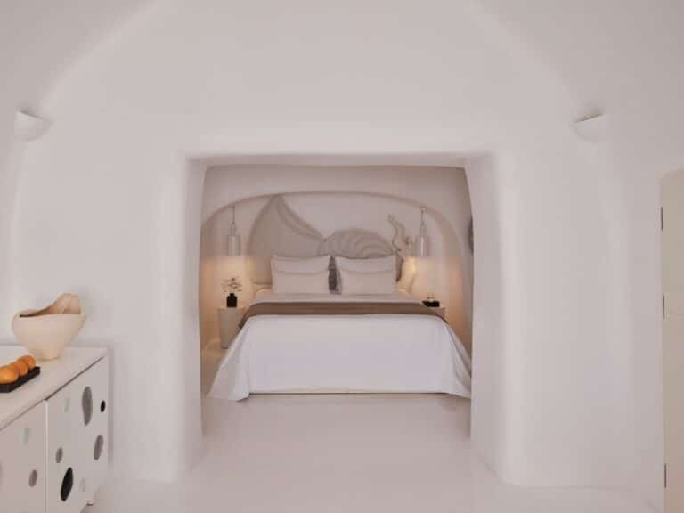 Bed set into a whitewashed cave alcove at Canaves Sunday, Oia, Santorini