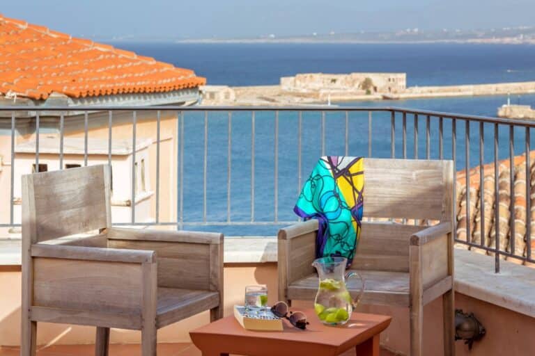 Balcony with armchairs and views over the harbour at Casa Delfino, Chania, Crete
