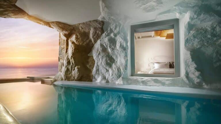 Cave-style suite opening onto an indoor pool at Cavo Tagoo, Mykonos