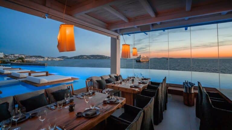 Restaurant terrace overlooking the infinity pool and sea at Cavo Tagoo, Mykonos