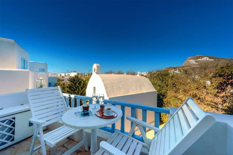 Balcony overlooking a whitewashed chapel and the hills at Chora Resort Hotel & Spa, Folegandros