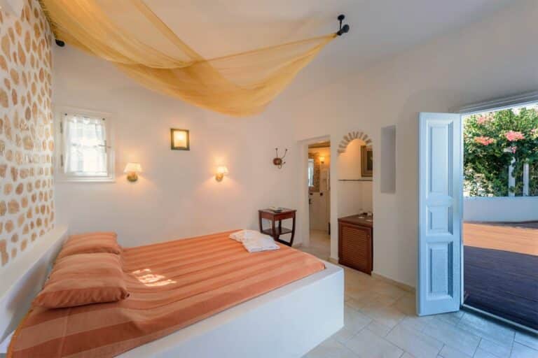 Bedroom opening onto a garden terrace at Chora Resort Hotel & Spa, Folegandros