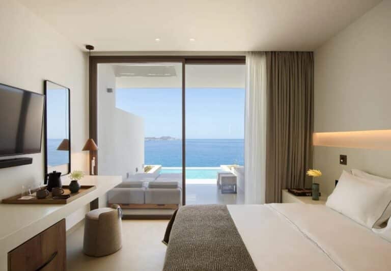 Suite with a double bed and floor-to-ceiling sea views at Domes White Coast, Mytakas, Milos