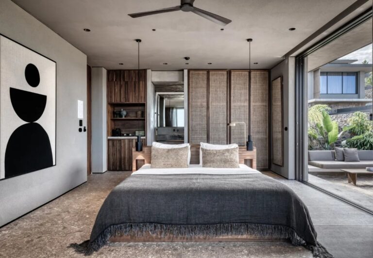 Bedroom with a graphic artwork and a wall of glass at Domes Zeen Chania, Crete