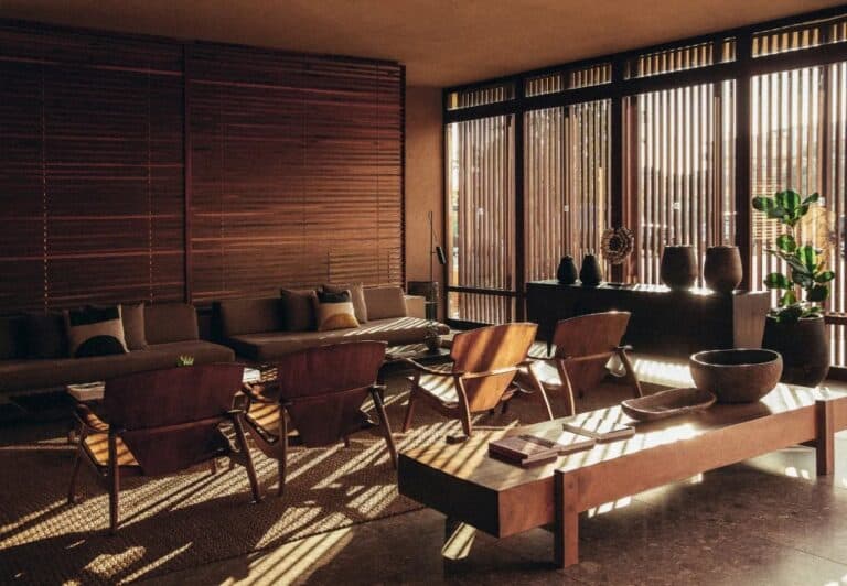 Lounge with wooden shutters and low seating at Domes Zeen Chania, Crete