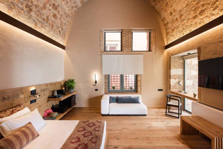 Suite with a vaulted stone ceiling and sitting area at Domus Renier, Chania, Crete