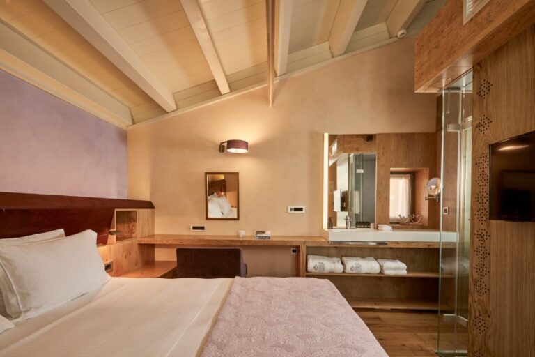 Attic bedroom with a beamed ceiling at Domus Renier, Chania, Crete