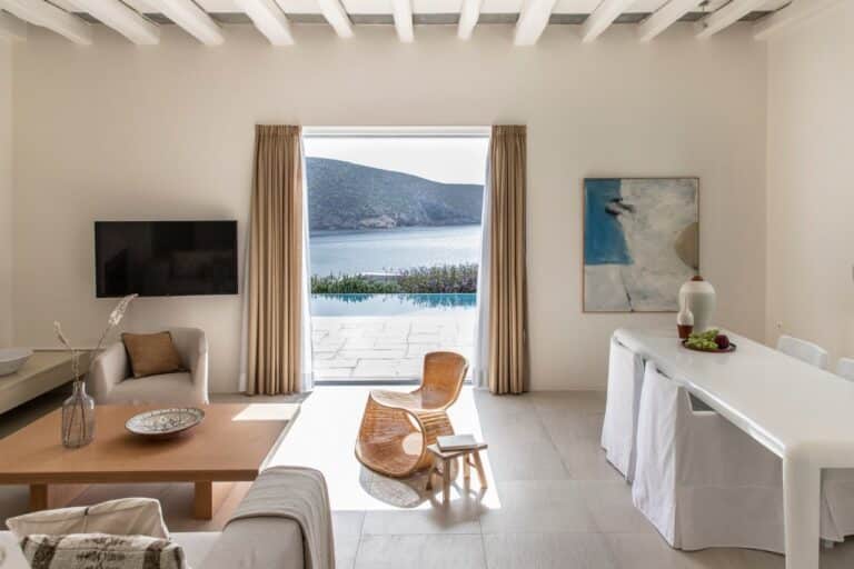 Suite living room opening onto a pool and the bay at Elies Resorts, Vathi, Sifnos