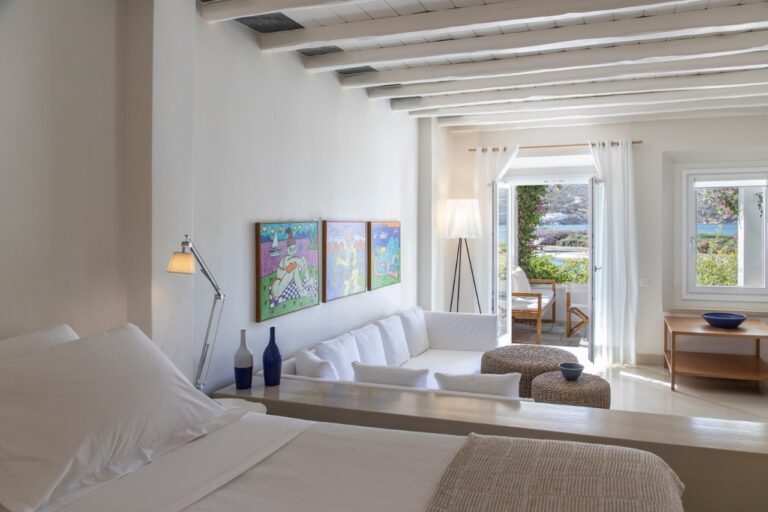 Suite with a sitting area and colourful artworks at Elies Resorts, Vathi, Sifnos